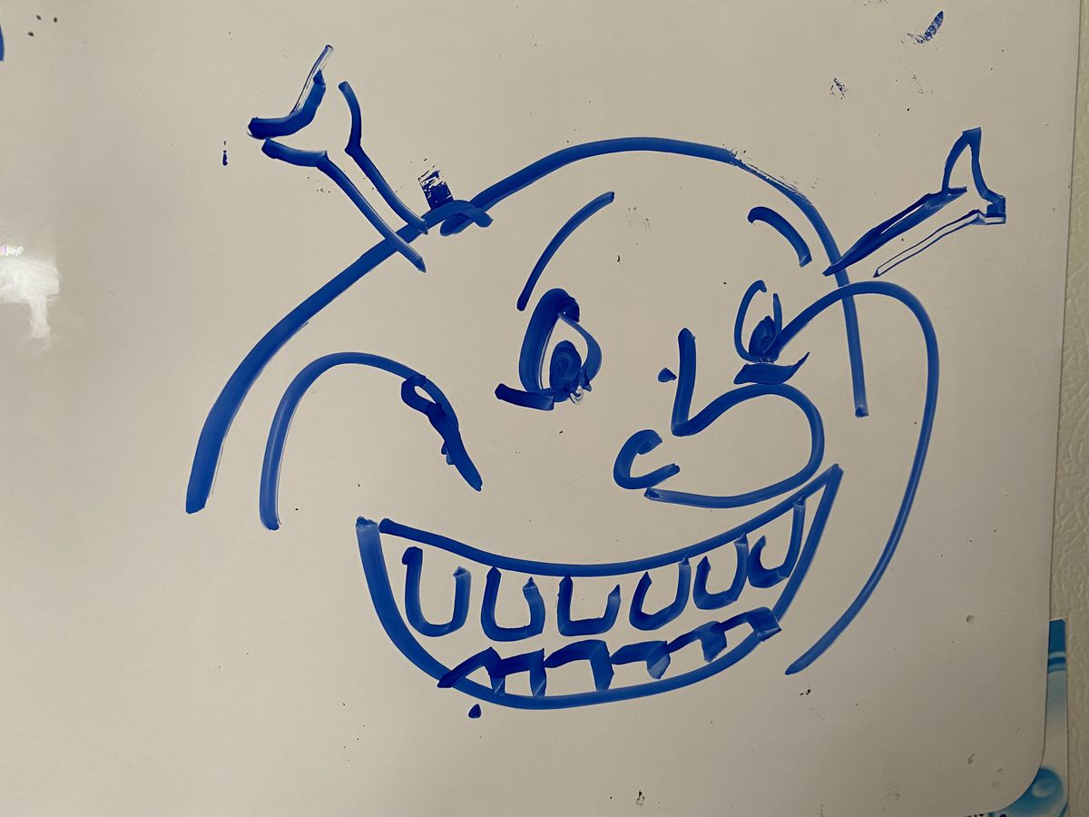 a whiteboard drawing of shrek 