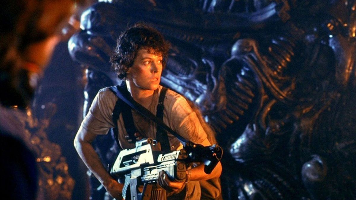 Ellen Ripley holding a firearm in the xenomorph hive in Aliens