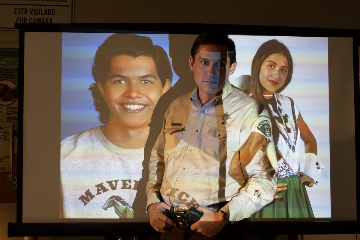 Panic’s sheriff stands in front of a projection of the two teenagers who died in a previous game of Panic