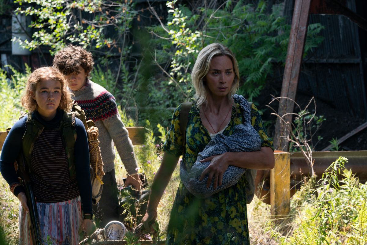 Regan, Marcus, and Evelyn walking through the woods in A Quiet Place Part II