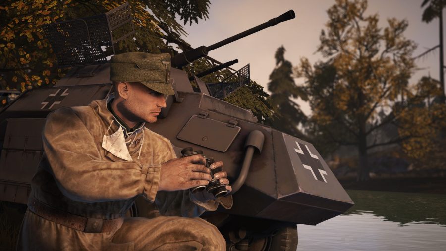 A soldier crouches next to a tank in one of the best tank games: Heroes & Generals