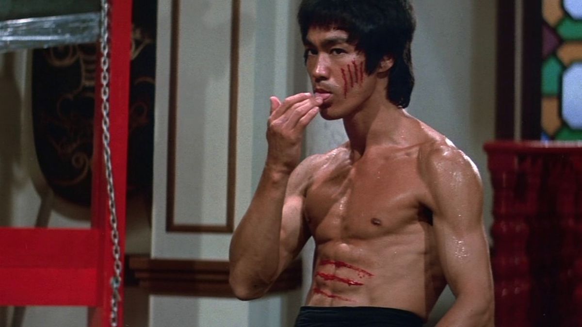 Bruce Lee taunting his opponent by licking his own wound