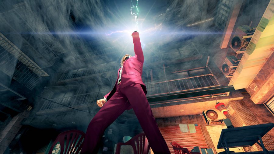 Ichiban, the hero of one of the best JRPGs Yakuza: Like a Dragon, is holding his phone aloft as it emits light.