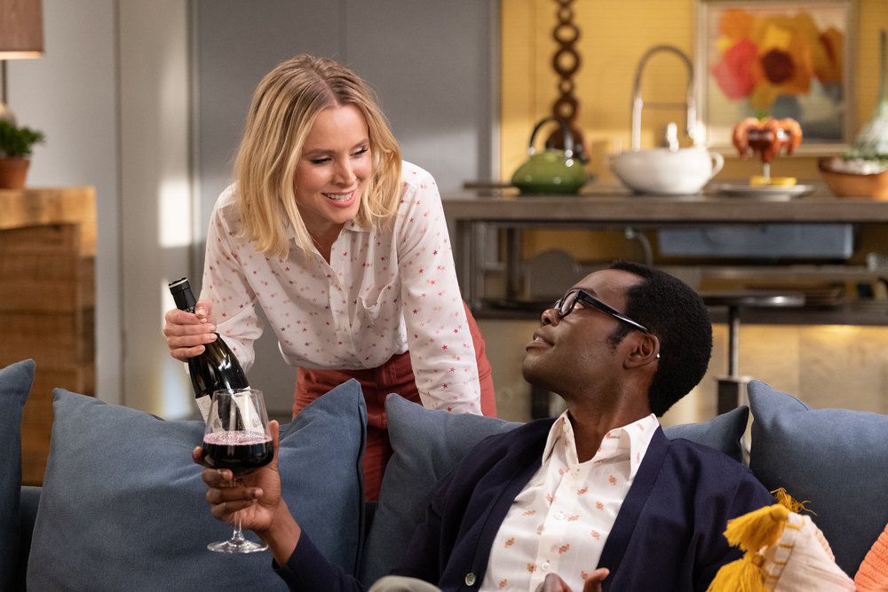 Eleanor (Kristen Bell) and Chidi (William Jackson Harper) share a bottle of wine in a screenshot from The Good Place season 4, episode 13, “Whenever You’re Ready”
