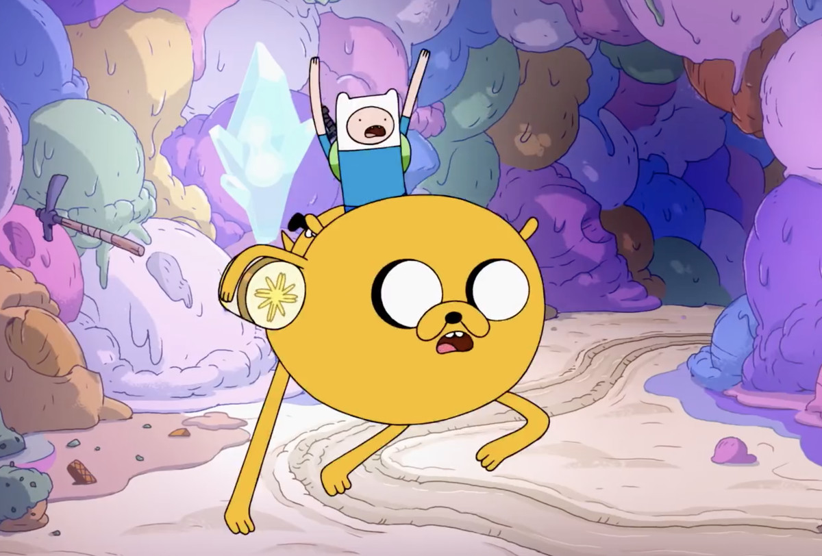 Finn the human riding jake the dog in an ice cream cave