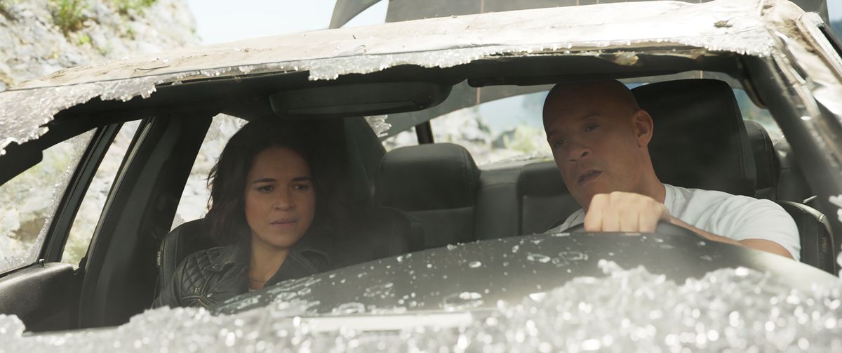 Letty and Dom sit in a car with a broken windshield in F9