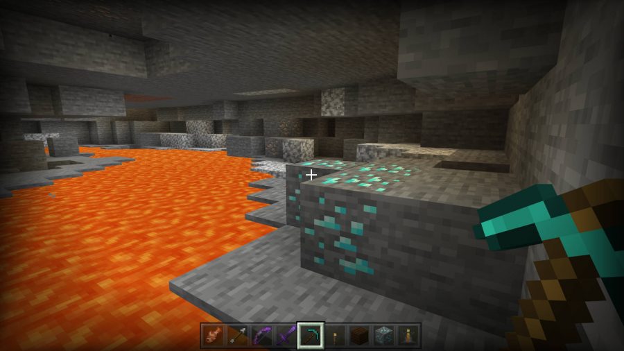 The player has found some diamond ore in Minecraft. It's perilously above some lava.