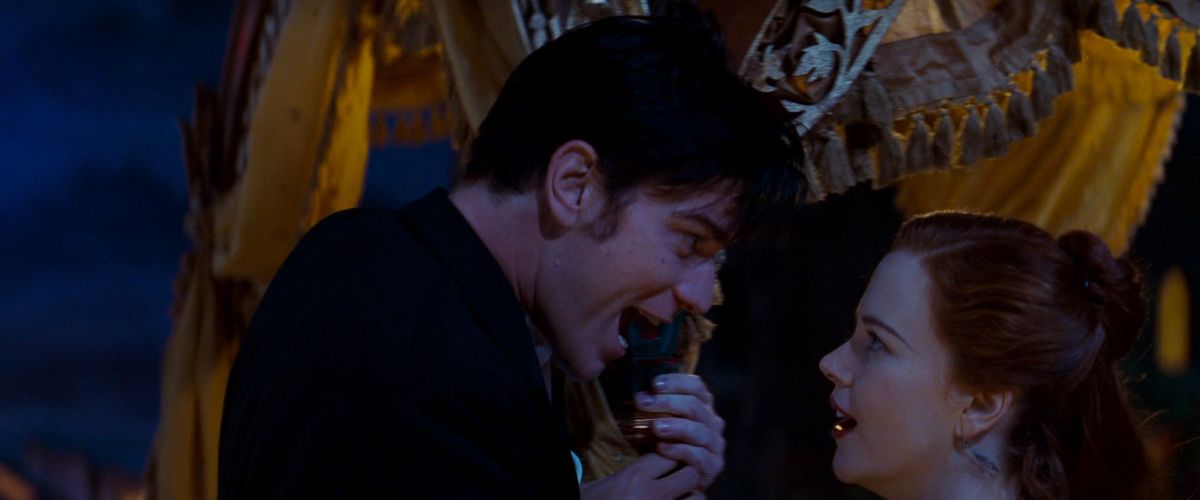 Ewan McGregor looms over Nicole Kidman, hard-sell singing love songs at her in Moulin Rouge