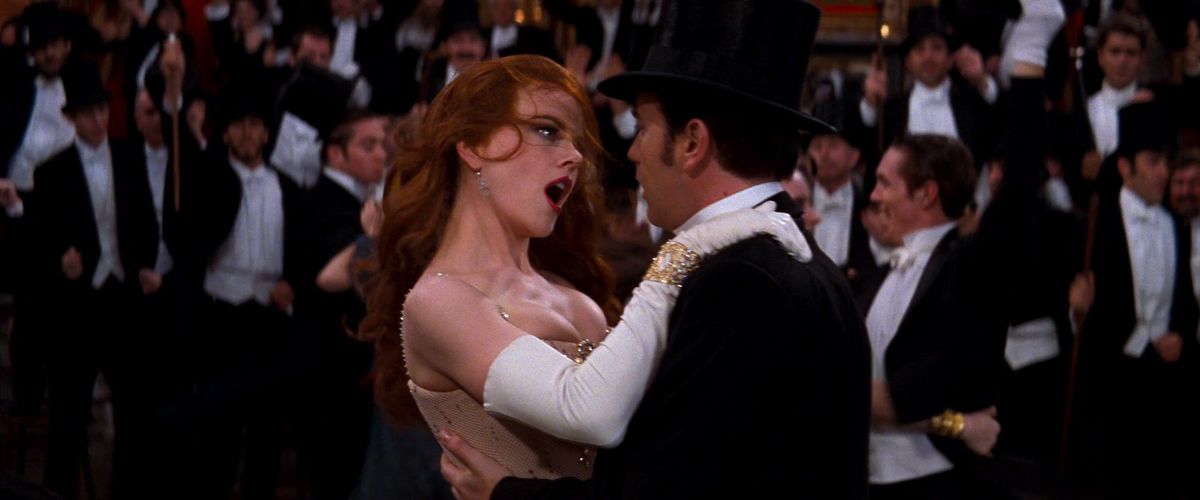 Nicole Kidman, hair askew, pulls Ewan McGregor in close in a dance in Moulin Rouge
