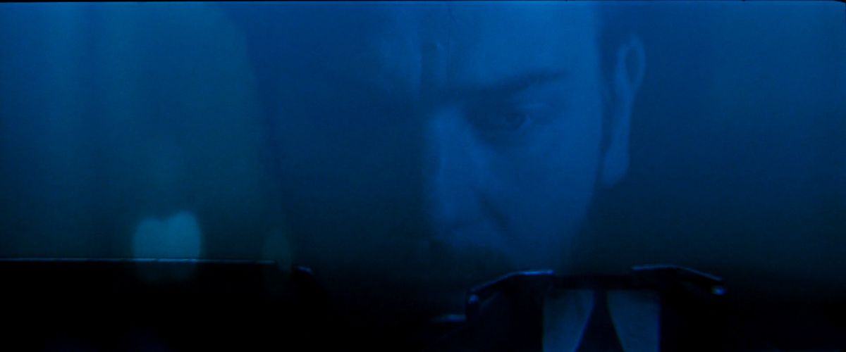 Ewan McGregor, in dim blue light, hunches over a typewriter in Moulin Rouge