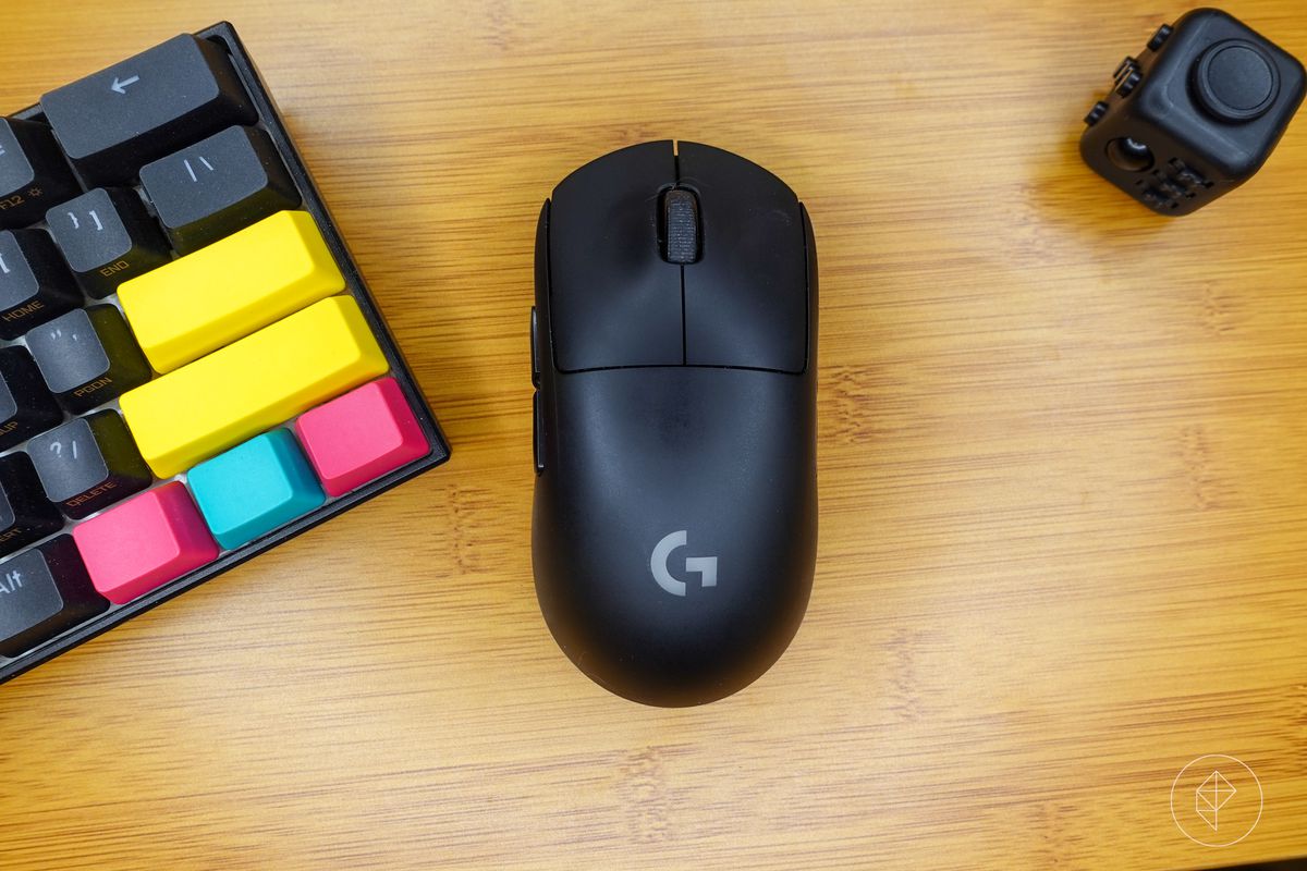 The Logitech G Pro Wireless on a desk near a keyboard and fidget cube