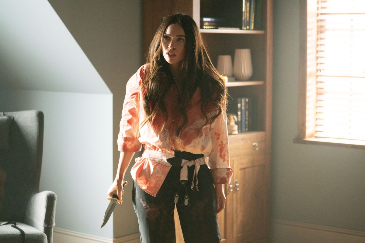 Megan Fox as Emma, covered in blood and brandishing a knife in Till Death