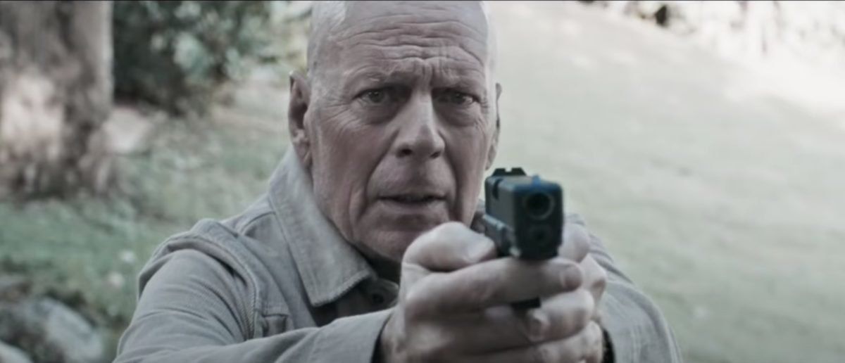 Bruce Willis holding a gun in Out of Death