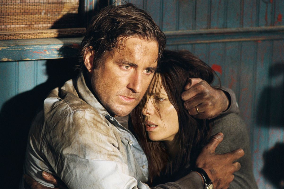 A grubby Luke Wilson puts protective arms around a grubby Kate Beckinsale as they both look shell-shocked in Vacancy
