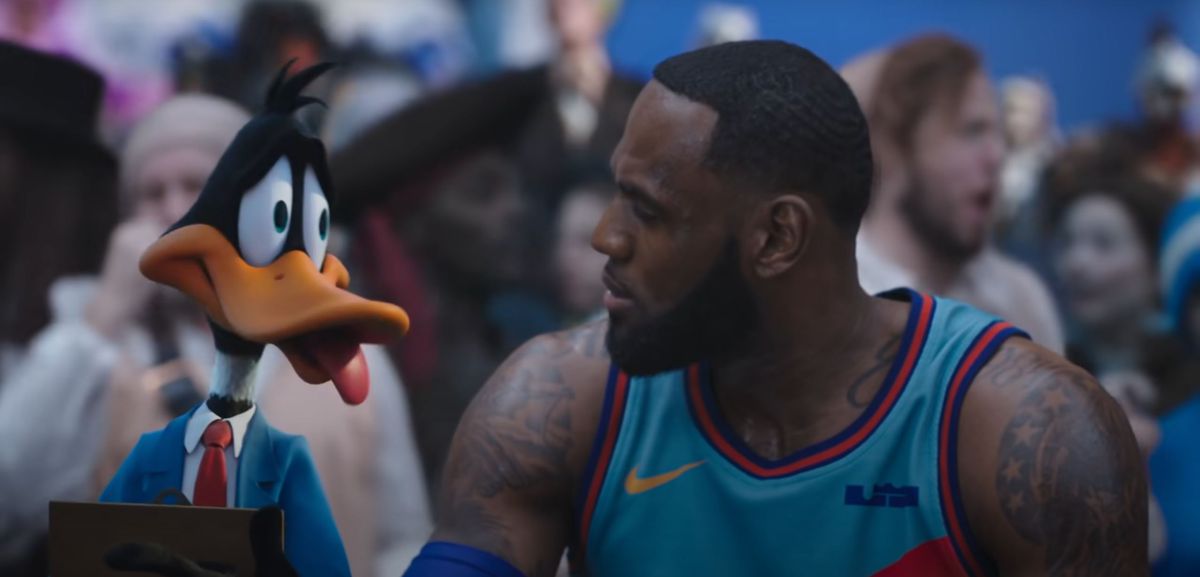 Daffy Duck and Lebron James exchange a look of chagrin on the sidelines of the Dom Ball game in Space Jam: A New Legacy