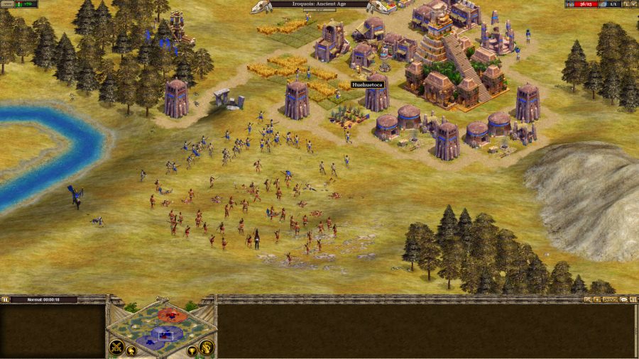 A shot of a town and some troops fighting on the outskirts in rise of nations