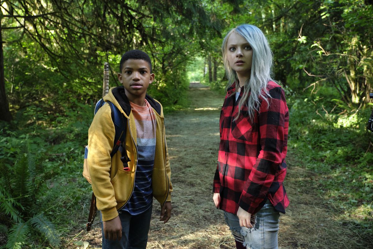Lonnie Chavis and Amiah Miller, as Gunner and Jo, stand in the forest looking baffled in The Water Man.