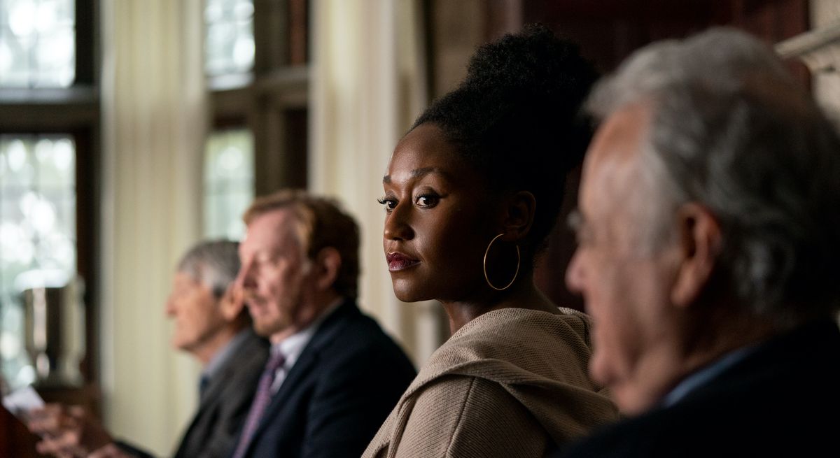 Nana Mensah as a young, Black professor in a line of much older white men in Netflix’s The Chair