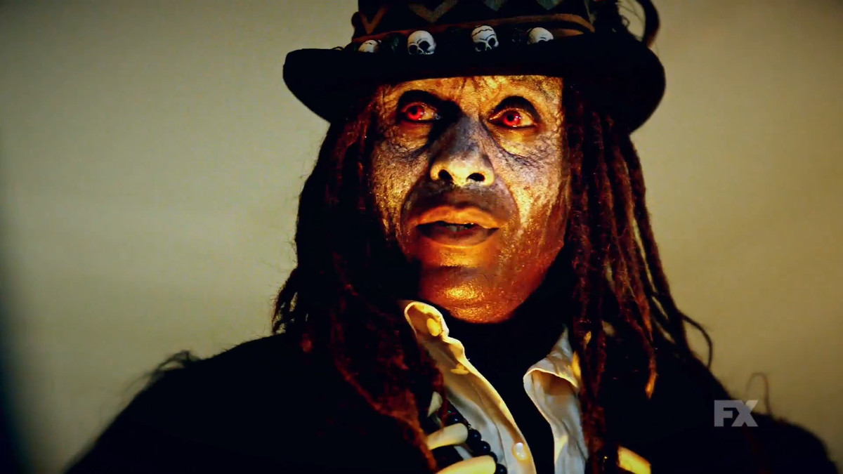 a man with face paint and long dreadlocks, with glowing red eyes, wearing a top hat