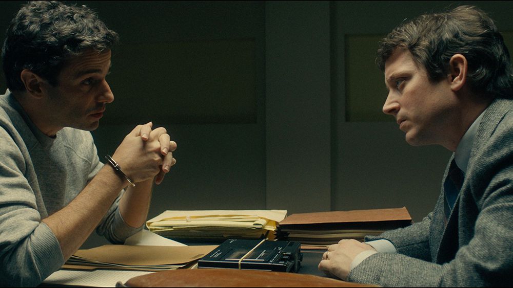 Ted Bundy (Luke Kirby) and Bill Hagmaier (Elijah Wood) sit across from one another in No Man of God