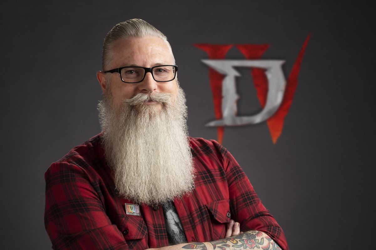 A photo of developer Jesse McCree in front of a Diablo 4 logo