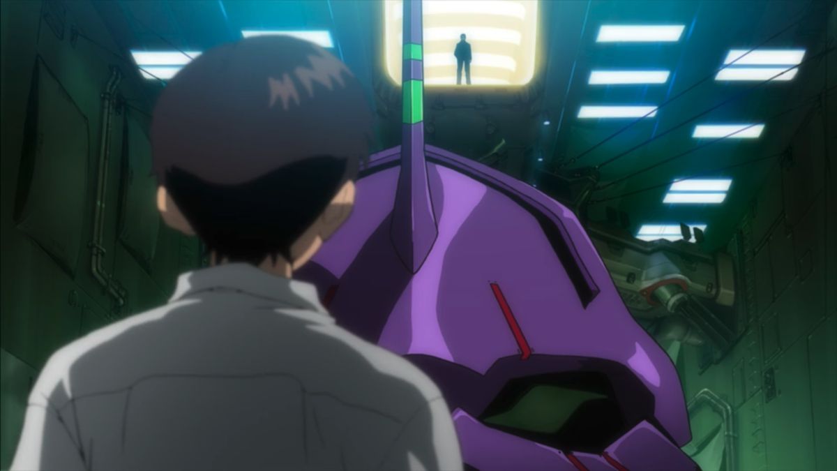 Shinji stands in front of his Evangelion with his father looming in the background in Evangelion: 1.0 You Are (Not) Alone 