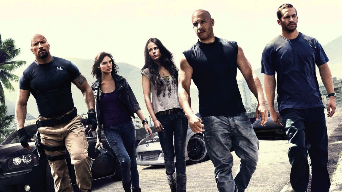 Fast Five’s cast walking together in a promo still, including Vin Diesel, Dwayne Johnson, and Gal Gadot