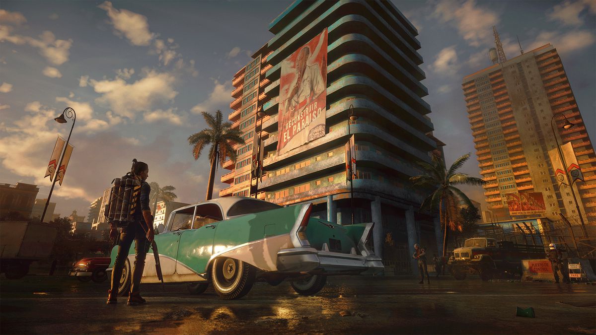 a man standing next to a classic sedan parked outside an apartment building in Far Cry 6