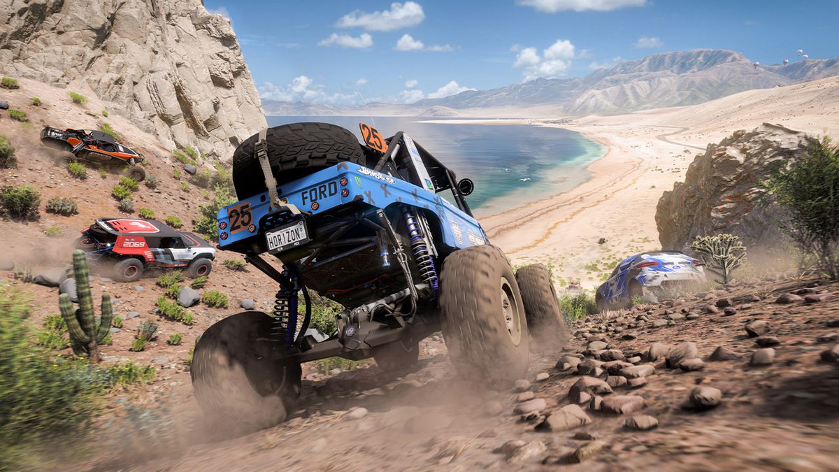 A Ford truck with large wheels rolls through hills above a beach in Forza Horizon 5