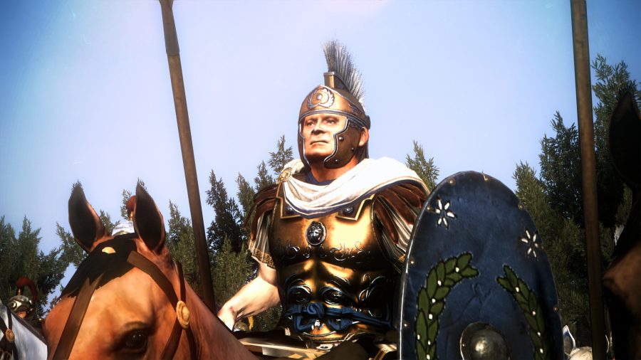 an aged armoured man sitting on a horse, holding a shield and spear